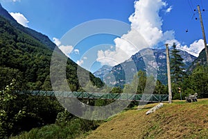 Wire rope bridge in front of the beautiful landscape of the Verzasca valley