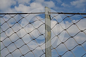 Wire stainless steel net made of ropes connected by metal connectors as a fence filling, loops, rope connectors, protective protec