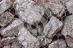 Wire stretched to encircle the rock to make a wall. photo