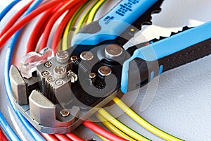 Wire stripper and cutter closeup with colored power cords