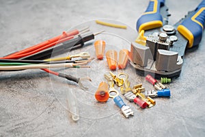 Wire strippers or cable strippers tool and Solderless Terminals on desk. Electrical tools concept ,selective focus photo