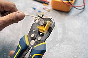 Wire strippers or cable strippers tool . Electrician holding cable strippers tool  to remove insulation from electrical wires photo