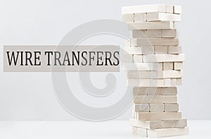WIRE TRANSFERS text with wooden block stack on white background , business concept