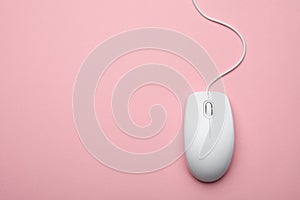 Wired computer mouse on pink background. Space for text