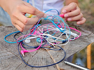 Wired in-ear headset bundle tangled in a messy knot