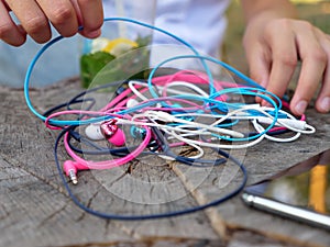 Wired in-ear headset bundle tangled in a messy knot