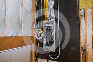 Wired electrical terminals on metal bar wiring cable box, residential house under construction photo