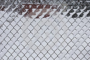 Wired fence background covered with fresh snow