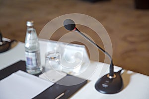 Wired microphone close up with copy space . Close up of microphone in concert hall or conference room . Wired microphone set up on