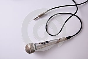 Wired microphone with jack connector on white table top view