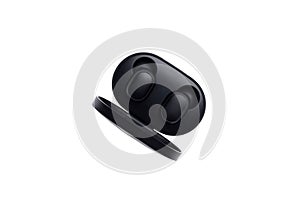 Wireless black bluetooth earphones with contactless charging isolated on a white background. Top view