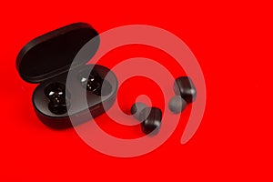 Wireless bluetooth headphones isolated on red background