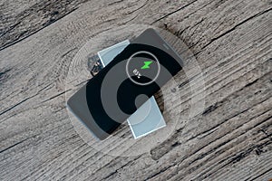 Wireless charging of smartphone on restaurant table, concept of charging sharing photo