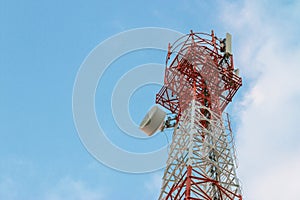 Wireless Communication Antenna Transmitter. Telecommunication tower with antennas on blue sky background.