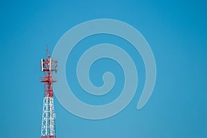 Wireless Communication Antenna Transmitter. Telecommunication tower with antennas on blue sky background.