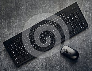 Wireless computer keyboard and mouse on gray background