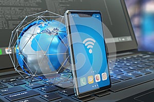 Wireless connection, internet symbols - globe model and smartphone with wifi connection icon on screen and modern laptop computer