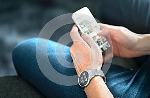 Wireless connection between smart watch and mobile phone. Man using wearable gadget and digital app. photo
