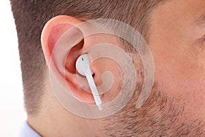 Wireless Earphone In Man`s Ear photo