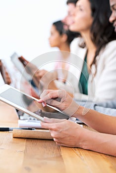 Wireless freedom in the boardroom. a group of businesspeople using their wireless devices during a meeting.