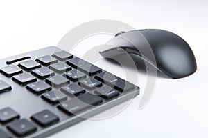 Wireless gray keyboard and mouse on a white background close-up.