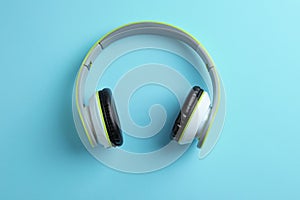 Wireless headphones on color background
