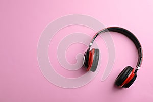 Wireless headphones on color background, top view