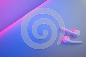 Wireless headphones on a colored background photo