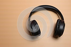 wireless headphones for listening to music on an orange background