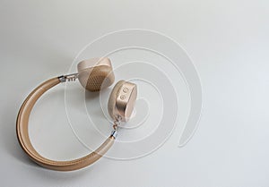 Wireless headset in gold color.
