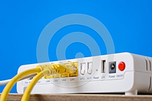 Wireless internet router with connecting cables on a blue background