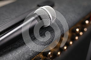 Wireless microphone on a black guitar amplifier, amp, closeup.