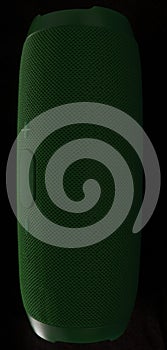 Wireless music column. Green buetooth speaker on black background.
