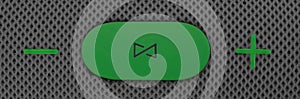 Wireless music column. Green control and volume buttons on gray speaker. Wallpaper and background