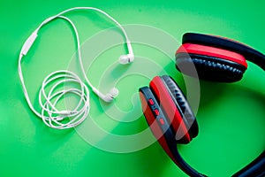 Wireless Over-Ear full size Headphones, Black and red leather isolated on green background with clipping path.set of