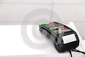 Wireless payment. credit card terminal on white cashbox