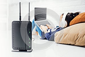 Wireless router and kids using a laptop in home