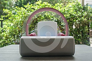 wireless speaker with pink headphones for music listening in freetime