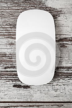 Wireless White Modern Computer Mouse on Light Wooden Background