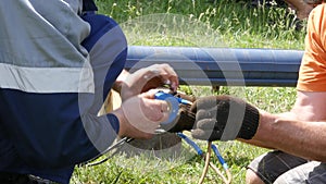 Wires connection and insulation, outdoor work . electrician hands, tools and wires. 4K