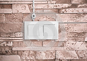 Wires and a switch on a stone wall