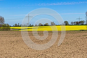 Wires of telecommunication towers against the blue sky captured in a rural area of farmlands