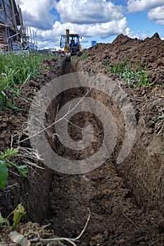 Wiring of an electric cable on the dug trench, supply of the electric power to the house on the earth
