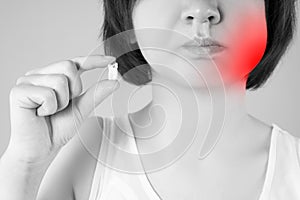 Wisdom tooth extraction, woman suffering from a toothache on gray background
