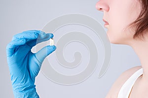 Wisdom tooth extraction, woman suffering from a toothache on gray background