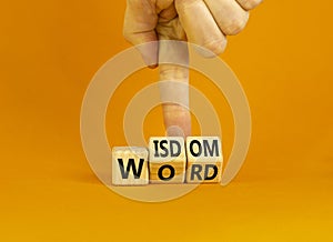 Wisdom word symbol. Concept words Wisdom word on wooden cubes. Businessman hand. Beautiful orange table orange background.