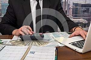 wise male businessman working with important documents at office desk.