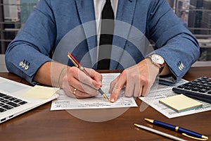 wise male businessman working with important documents at office desk.