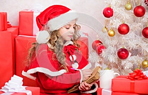 Wish list. Kid santa hat enjoy christmas eve. Child writing letter to santa claus. Dear santa. Girl little cute child