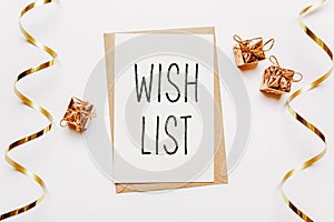 wish list note with envelope  gifts and gold ribbon on white background. merry christmas and New Year concept